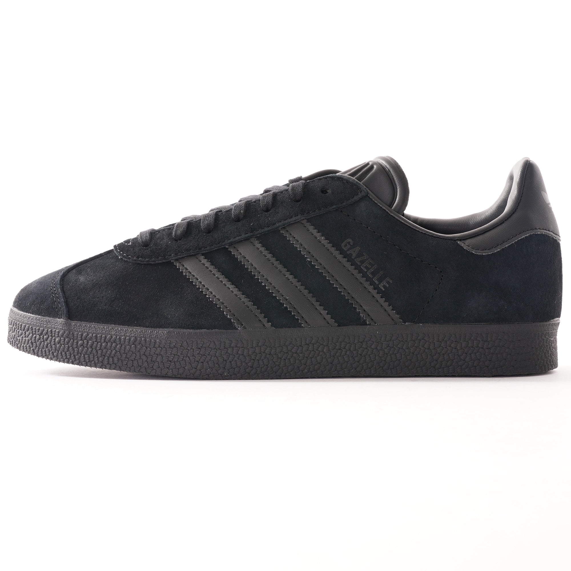 A single black Adidas Gazelle trainer, photographed from the side.