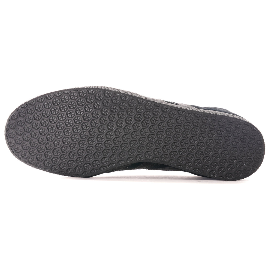 The textured black sole of an Adidas Gazelle trainer.