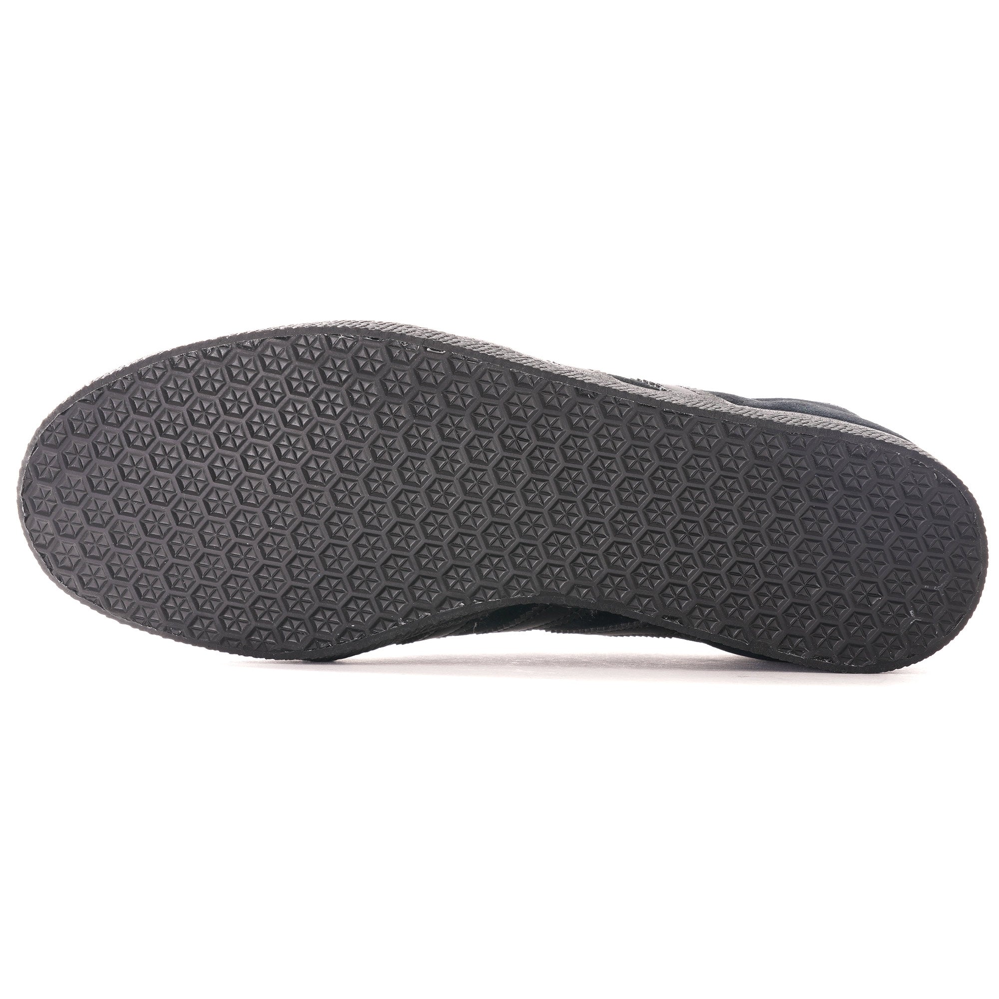 The textured black sole of an Adidas Gazelle trainer.