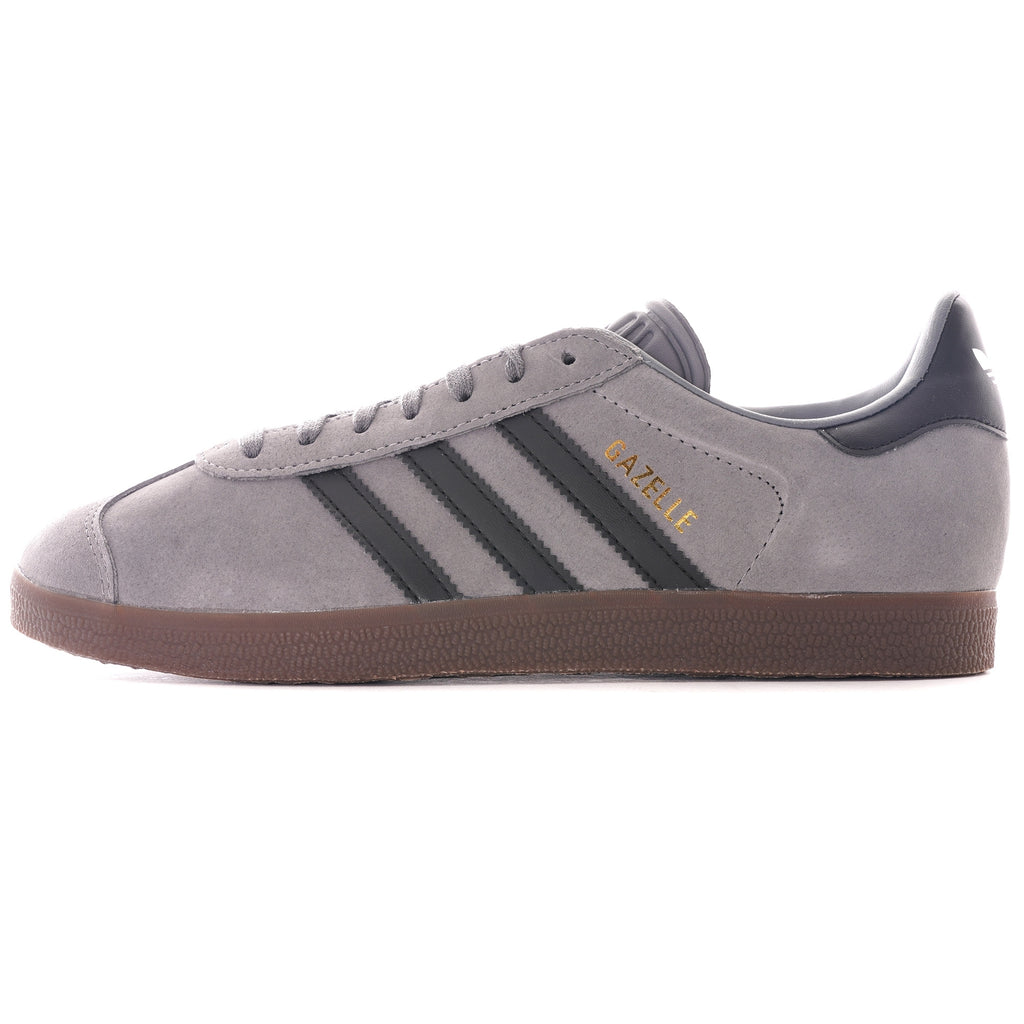 A single grey Adidas Gazelle trainer with black stripes and brown sole, viewed from the side.