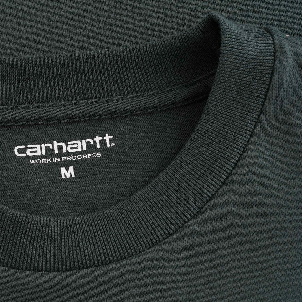 A close-up of the Carhartt WIP neck label and ribbed collar on the dark green t-shirt.