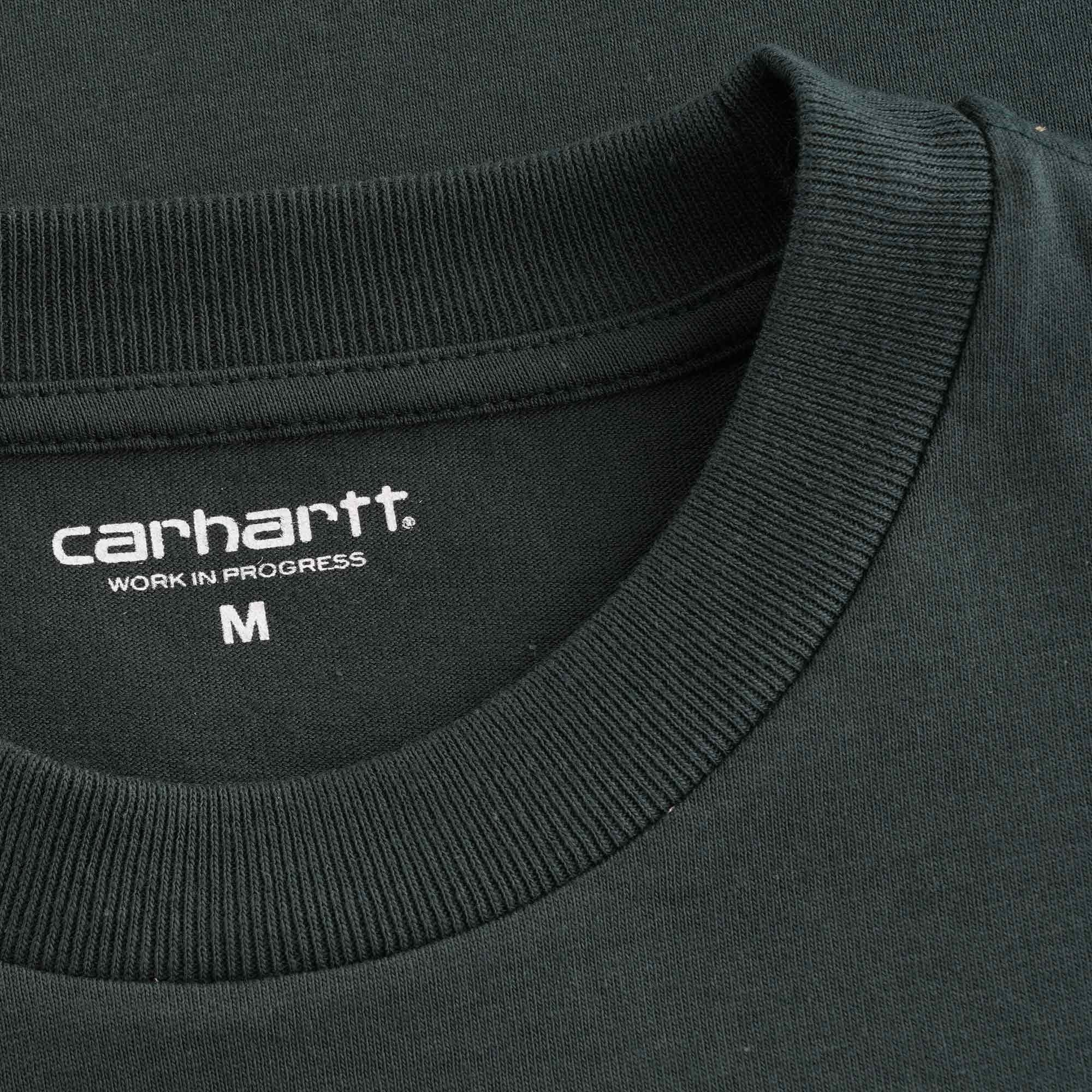 A close-up of the Carhartt WIP neck label and ribbed collar on the dark green t-shirt.
