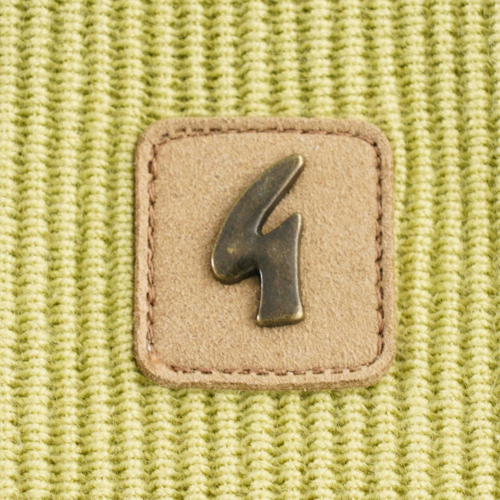 A detailed shot of the square brand patch with a metallic '4' logo.