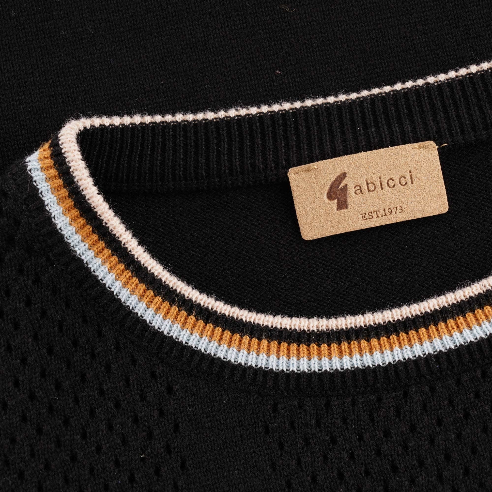 Close-up of the Gabicci label and striped collar on a black knitted top.