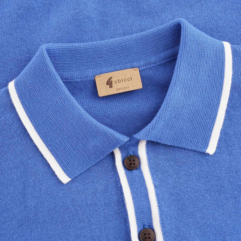 Close-up of the polo shirt's collar, showing white trim and a brown brand label.