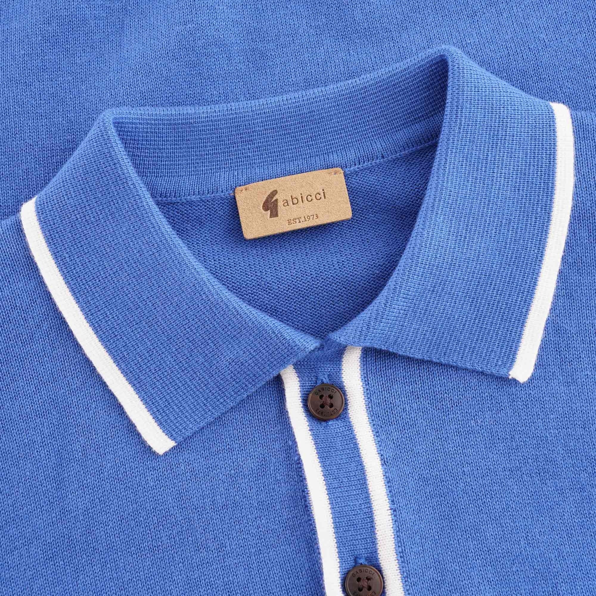Close-up of the polo shirt's collar, showing white trim and a brown brand label.