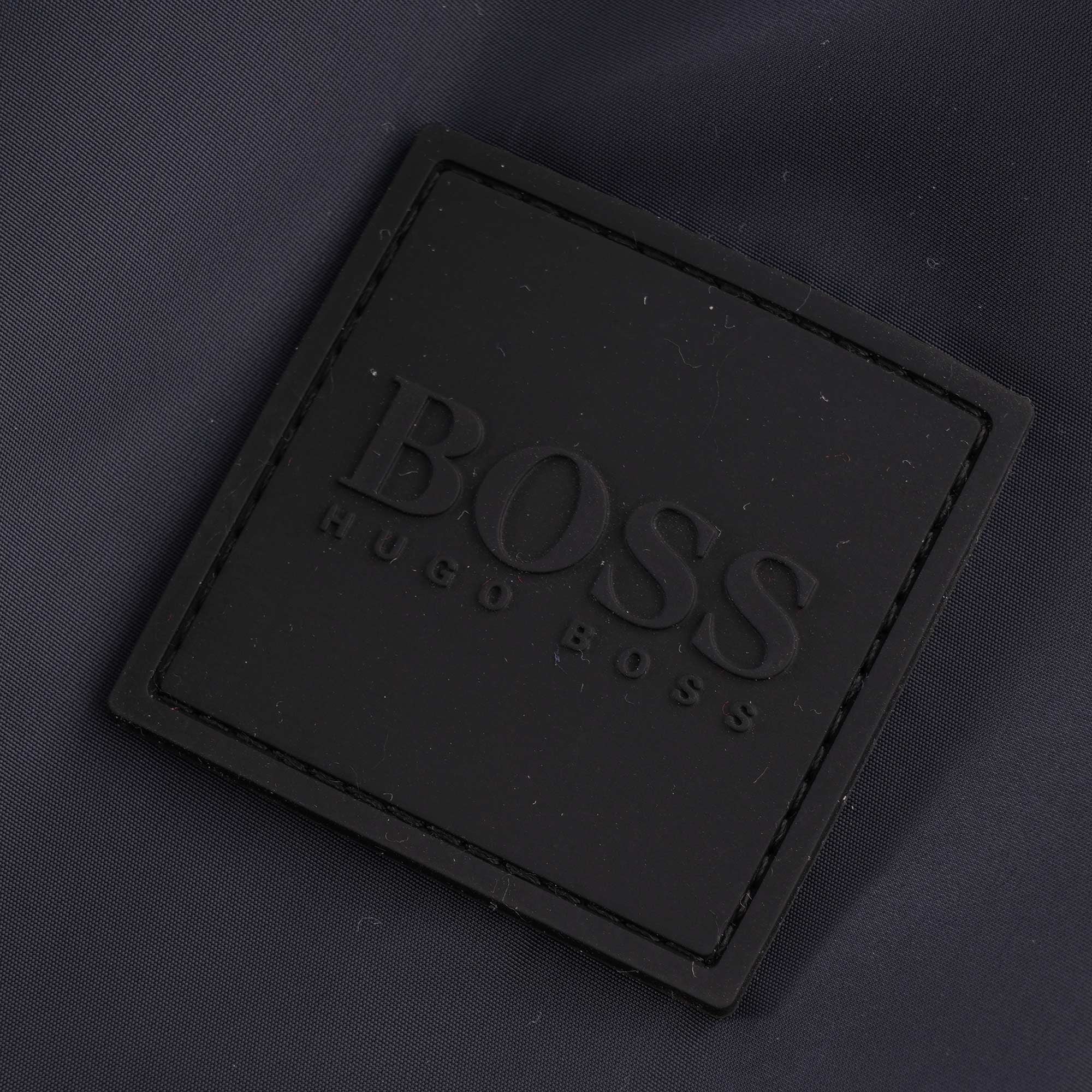 Close-up of the BOSS Hugo Boss logo patch on the jacket.