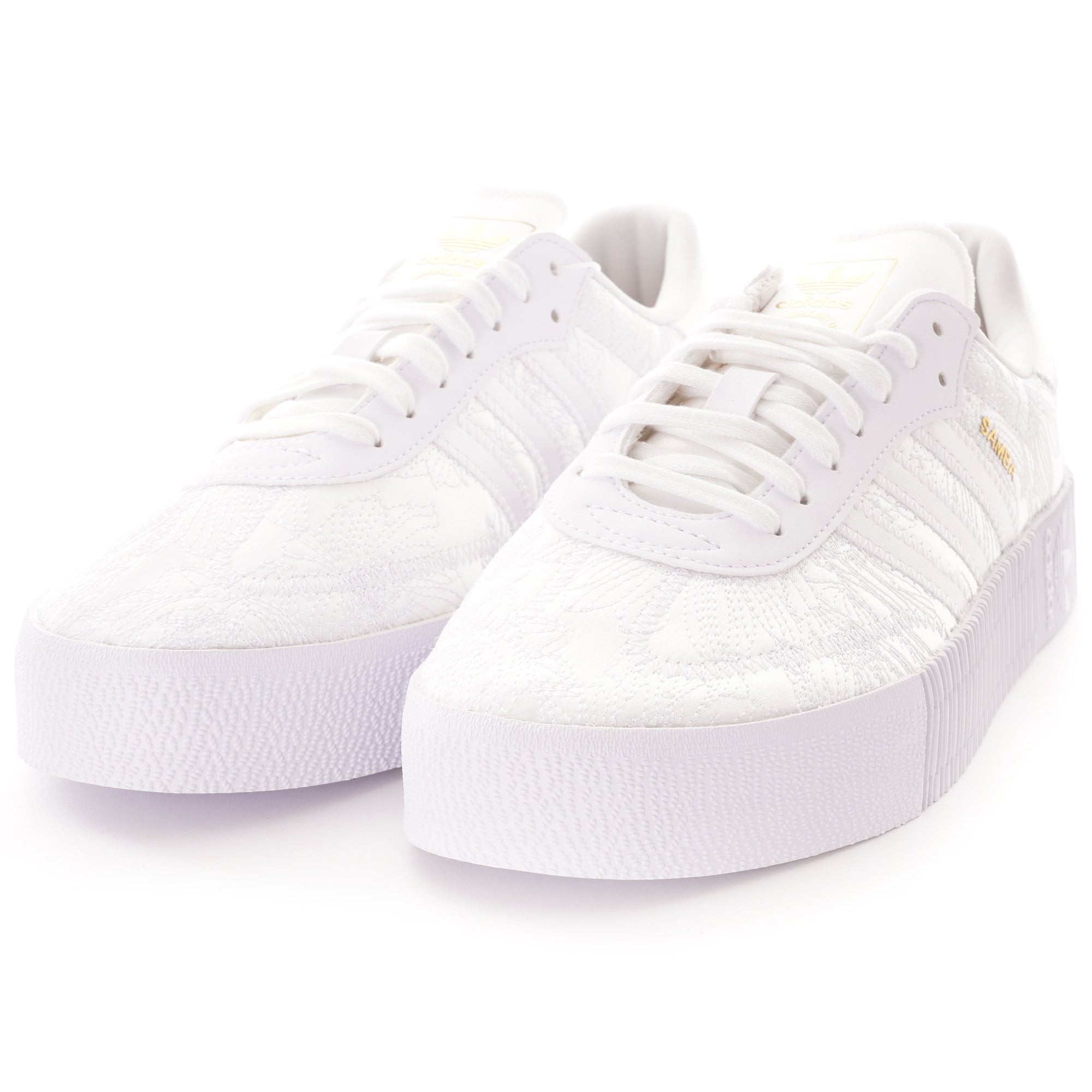 A pair of white Adidas Sambarose trainers, front-angled view, on a white background.