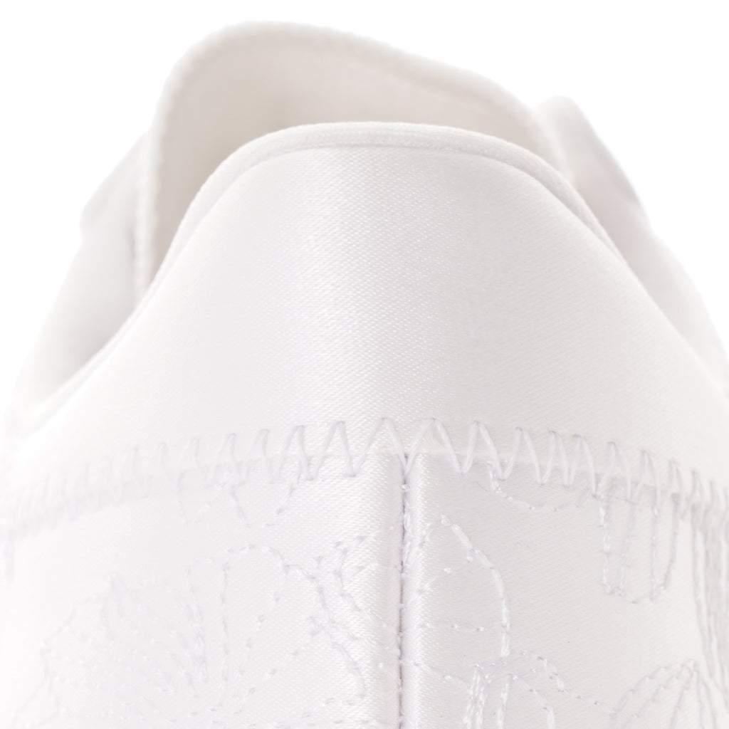 Close-up of the heel of a white Adidas Sambarose trainer, showing stitching detail.