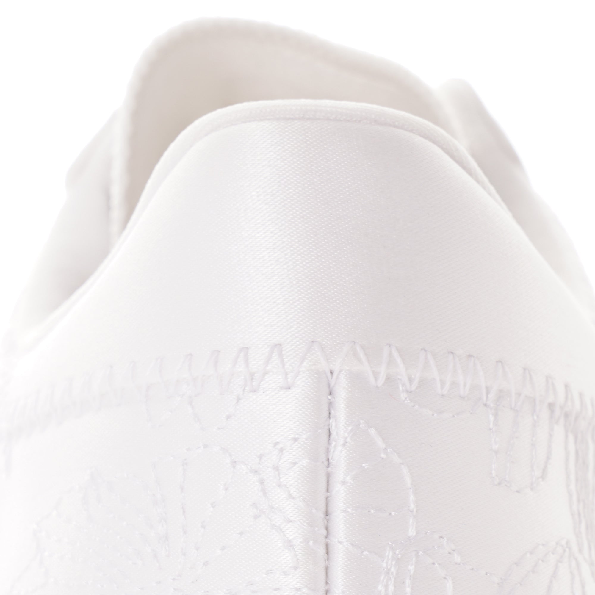 Close-up of the heel of a white Adidas Sambarose trainer, showing stitching detail.