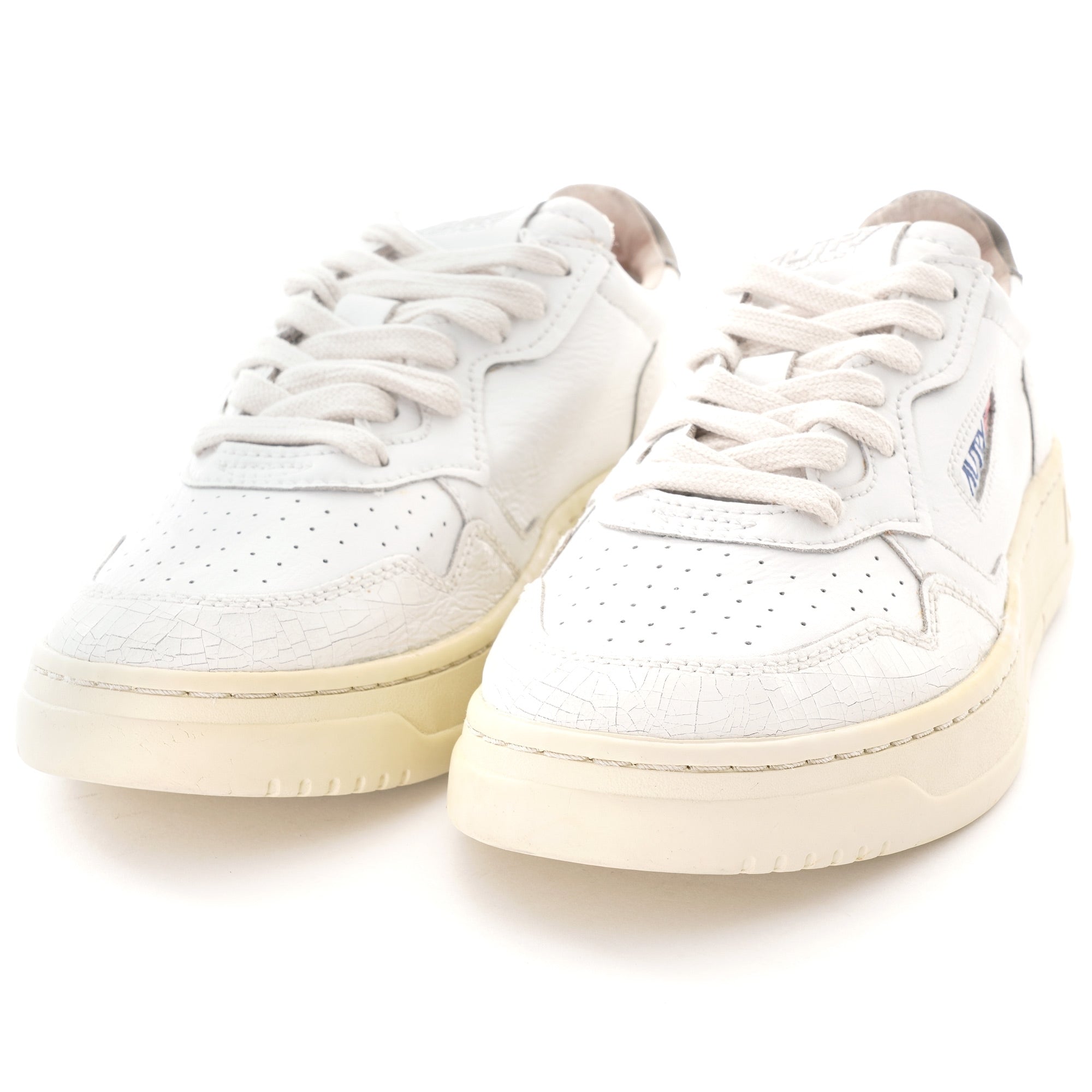 A pair of white Autry Medalist trainers, front three-quarter view, on a white background.