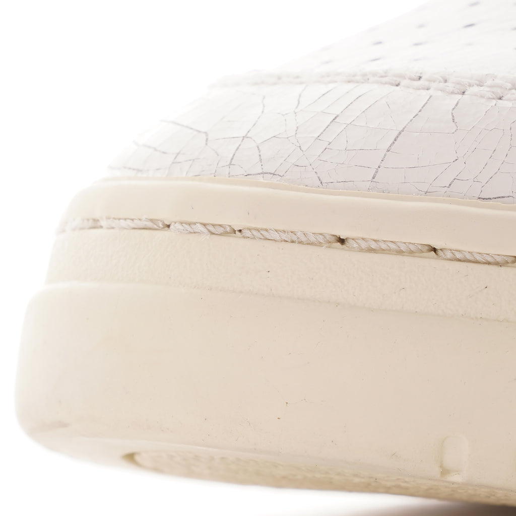 Close-up of the cracked leather detail on the toe of an Autry Medalist trainer.