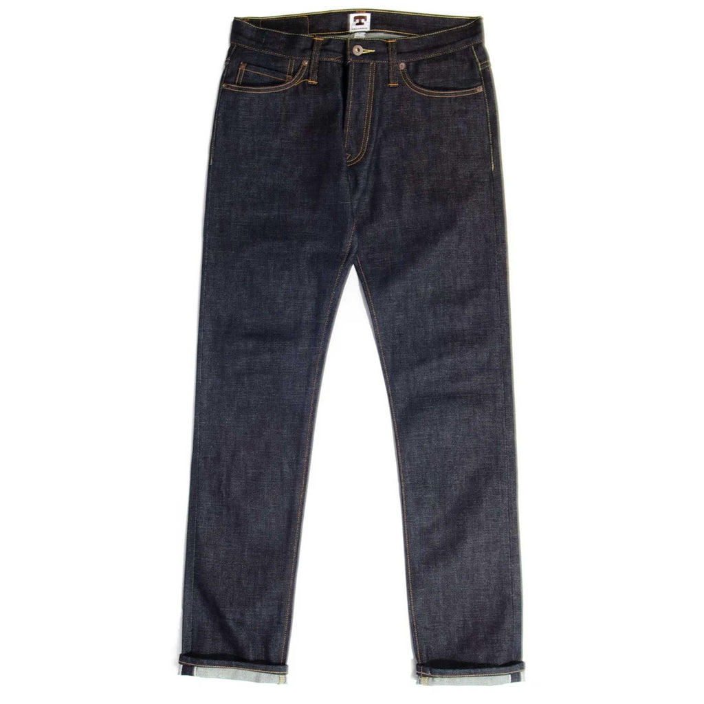 Dark blue denim jeans with a slight taper and cuffed hems on a white background.
