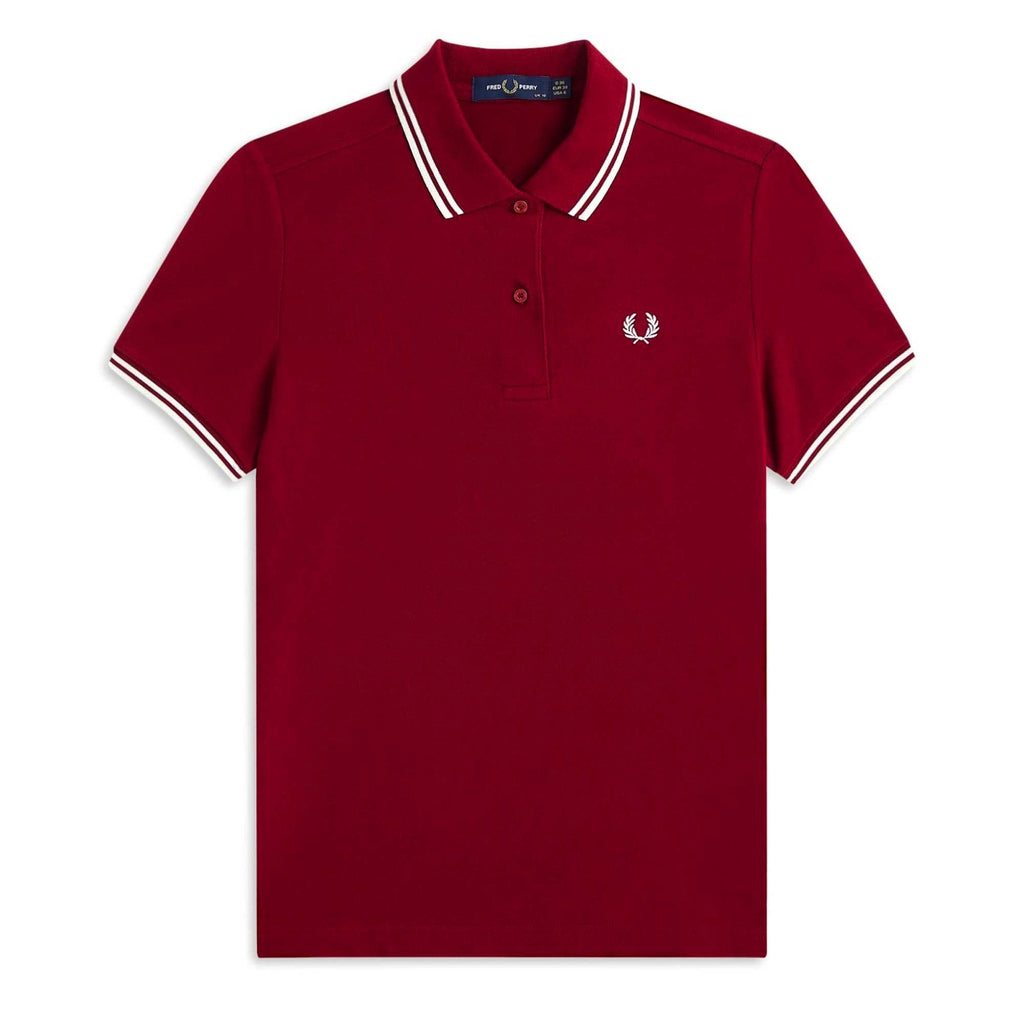 A close-up of a Fred Perry polo shirt in a rich, dark red with white twin-tipping.