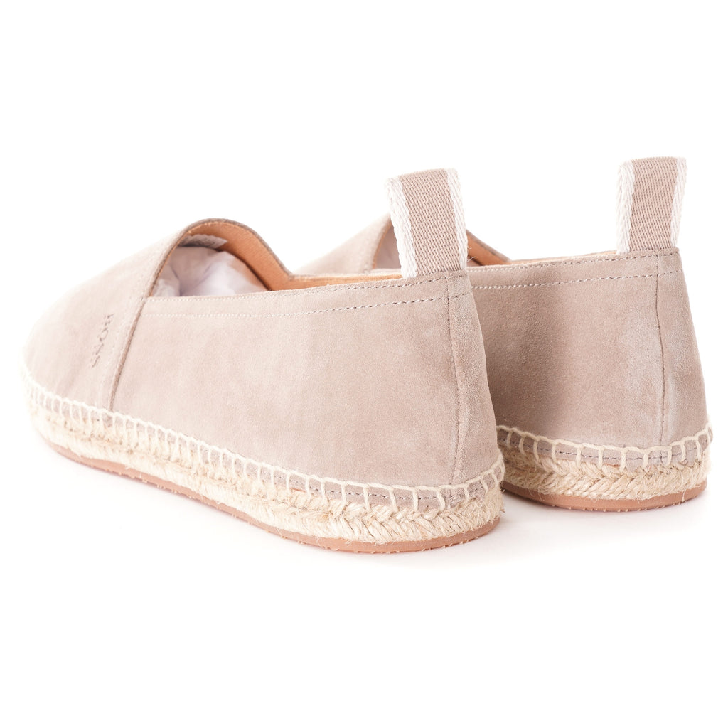 Rear view of a pair of light beige suede espadrilles, showing the heel and braided soles.