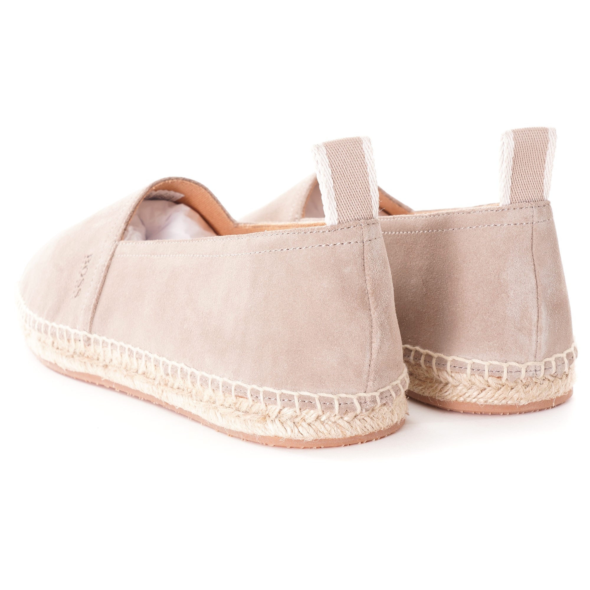 Rear view of a pair of light beige suede espadrilles, showing the heel and braided soles.