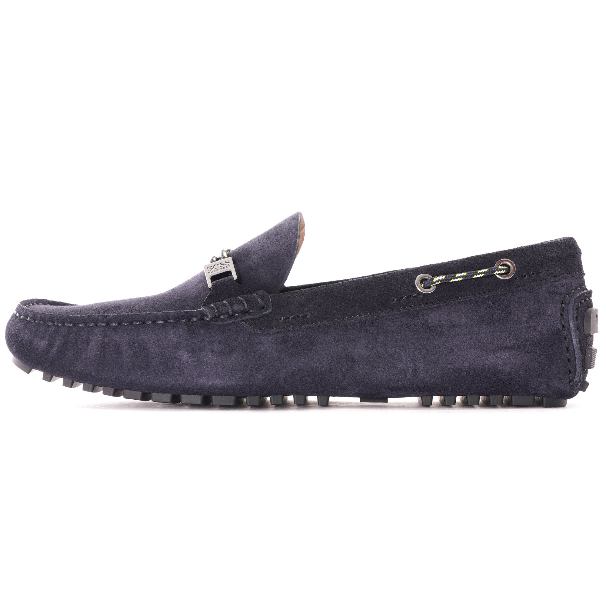 A close-up side view of a single dark blue suede loafer with a silver buckle.