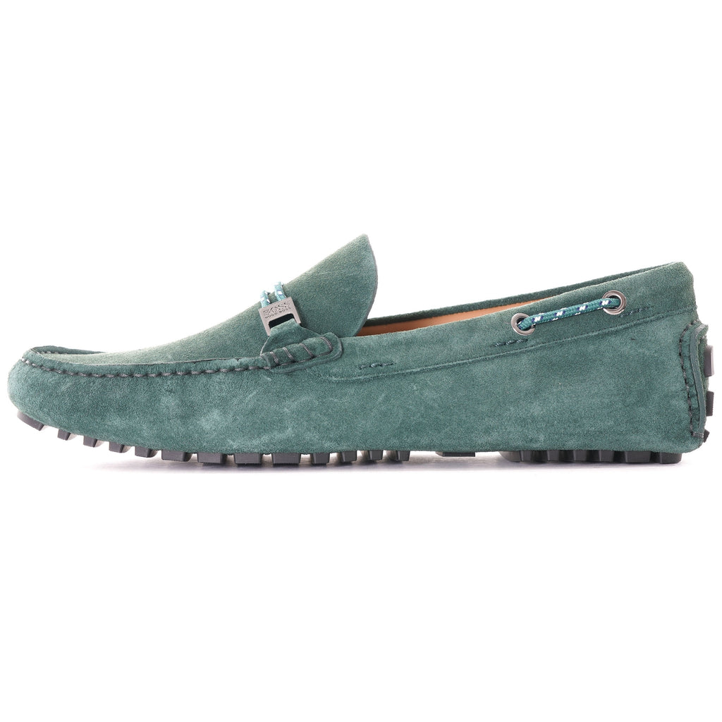 Side profile of a single green suede loafer with a grey buckle.