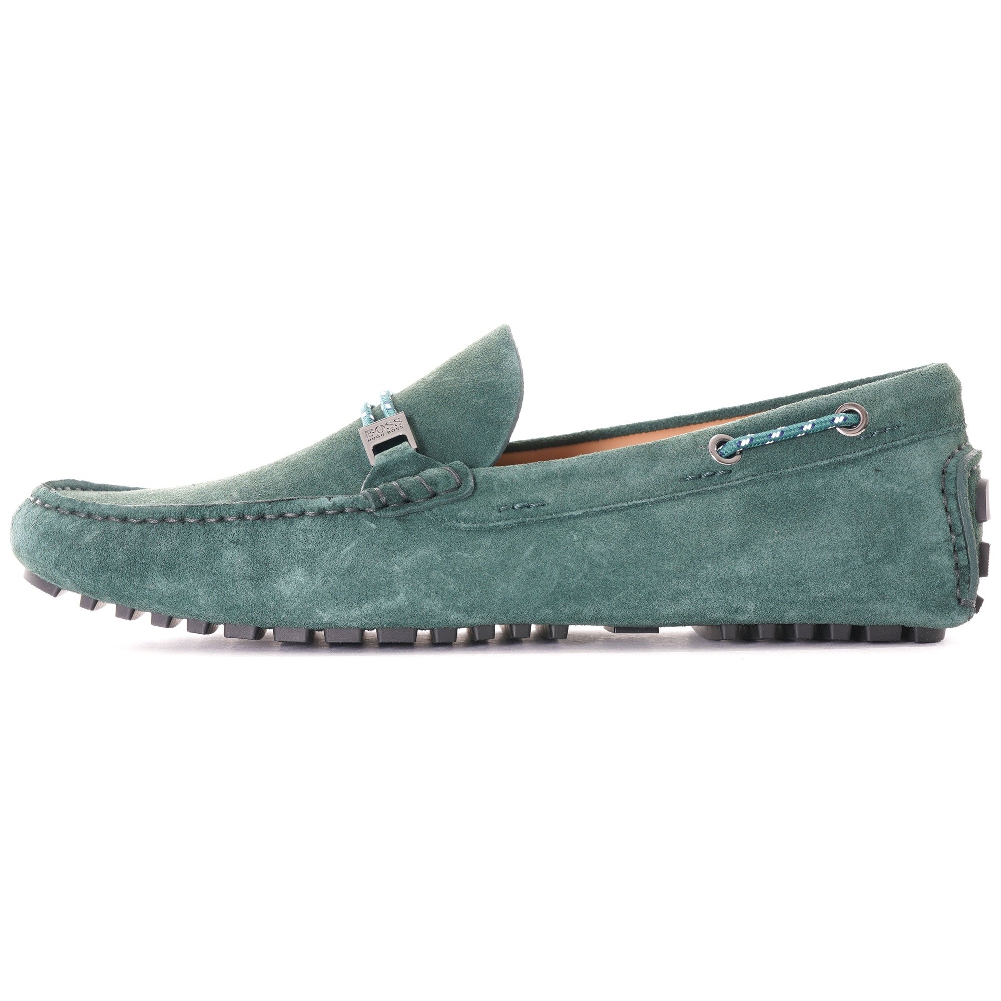 Side profile of a single green suede loafer with a grey buckle.