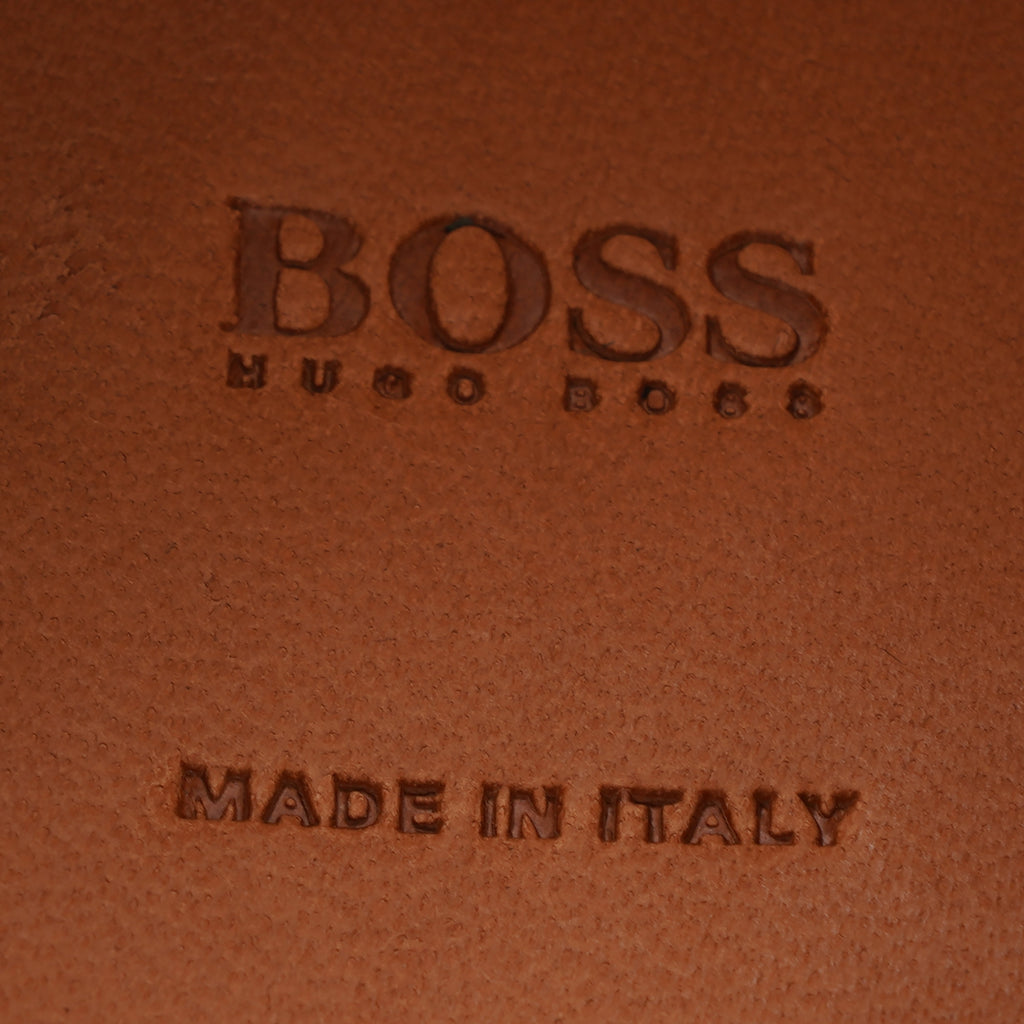 BOSS Hugo Boss and 'Made in Italy' embossed on brown leather.