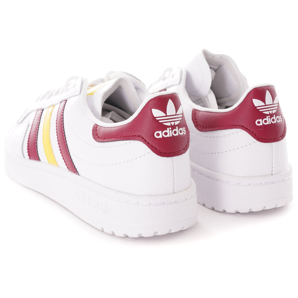 The heels of two white Adidas trainers with burgundy details and logo.