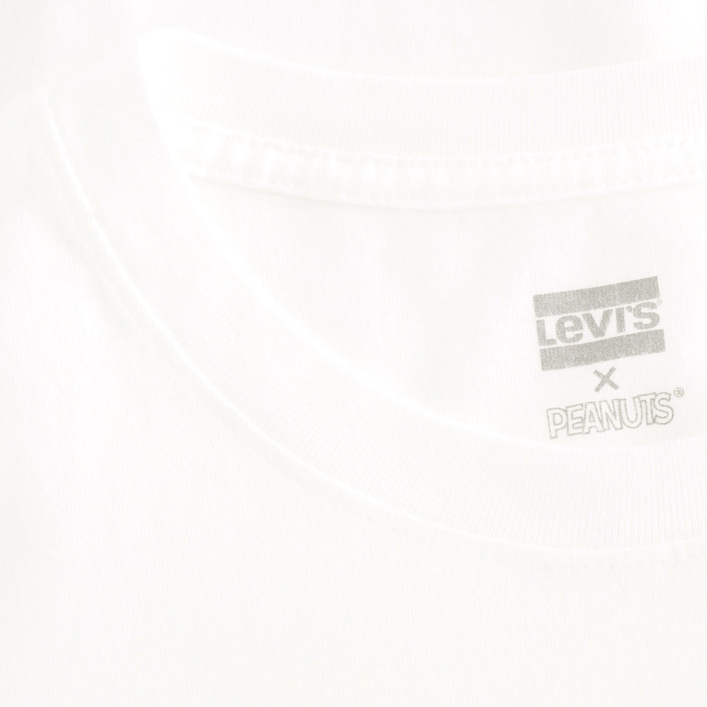 A close-up of the Levi's x Peanuts tag on a white t-shirt.