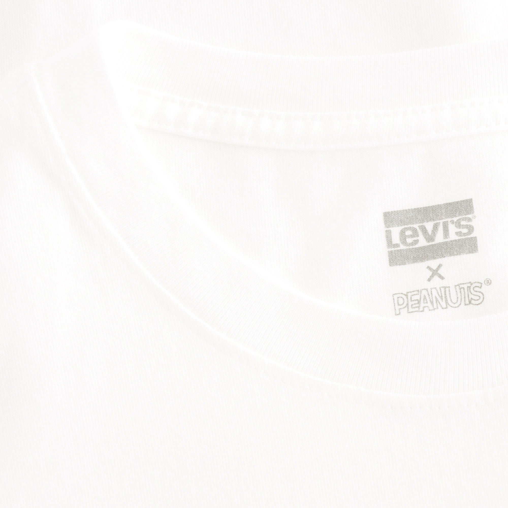 A close-up of the Levi's x Peanuts tag on a white t-shirt.
