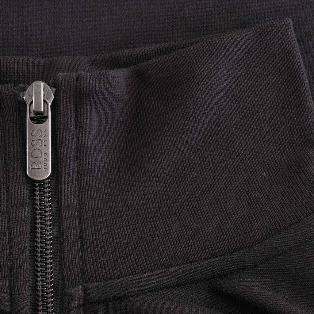 Close-up of the black ribbed collar and silver BOSS branded zip pull of the track jacket.