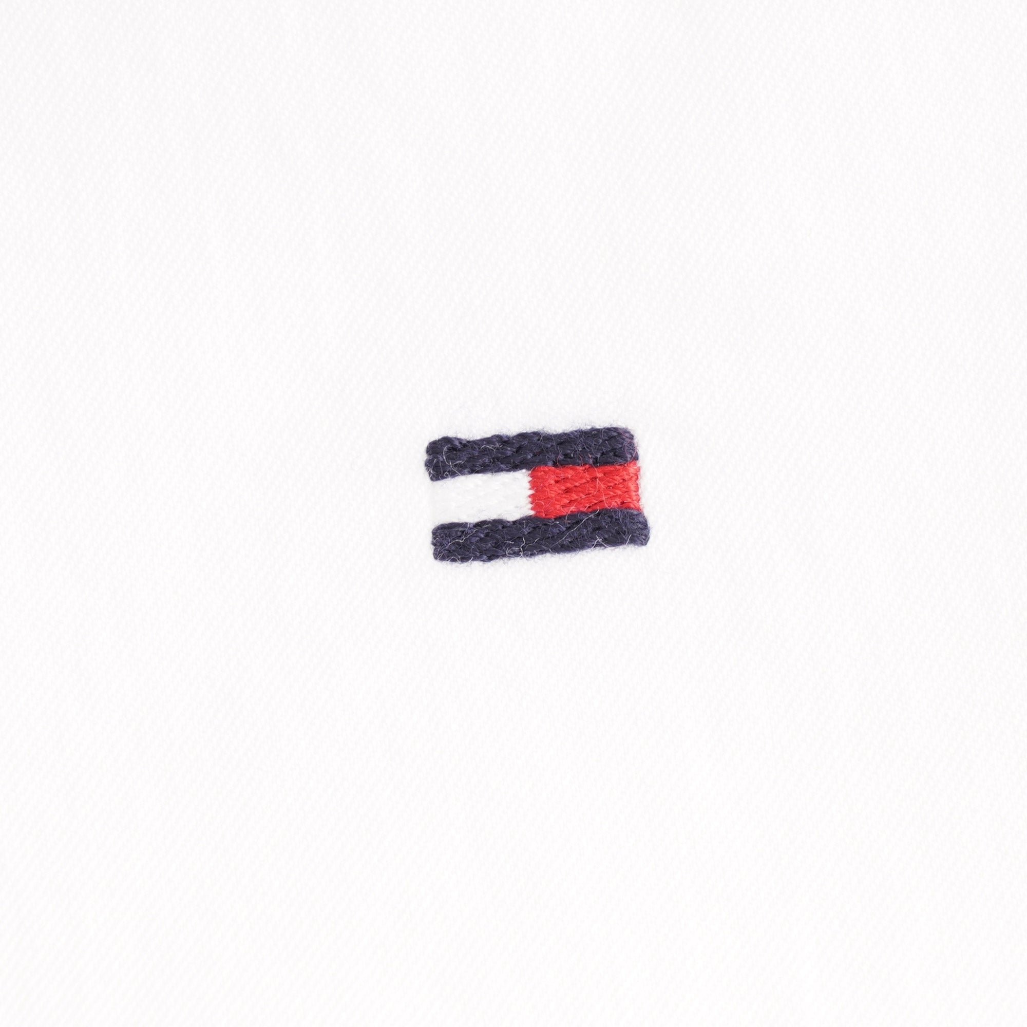A close up of the Tommy Hilfiger logo on a white background.