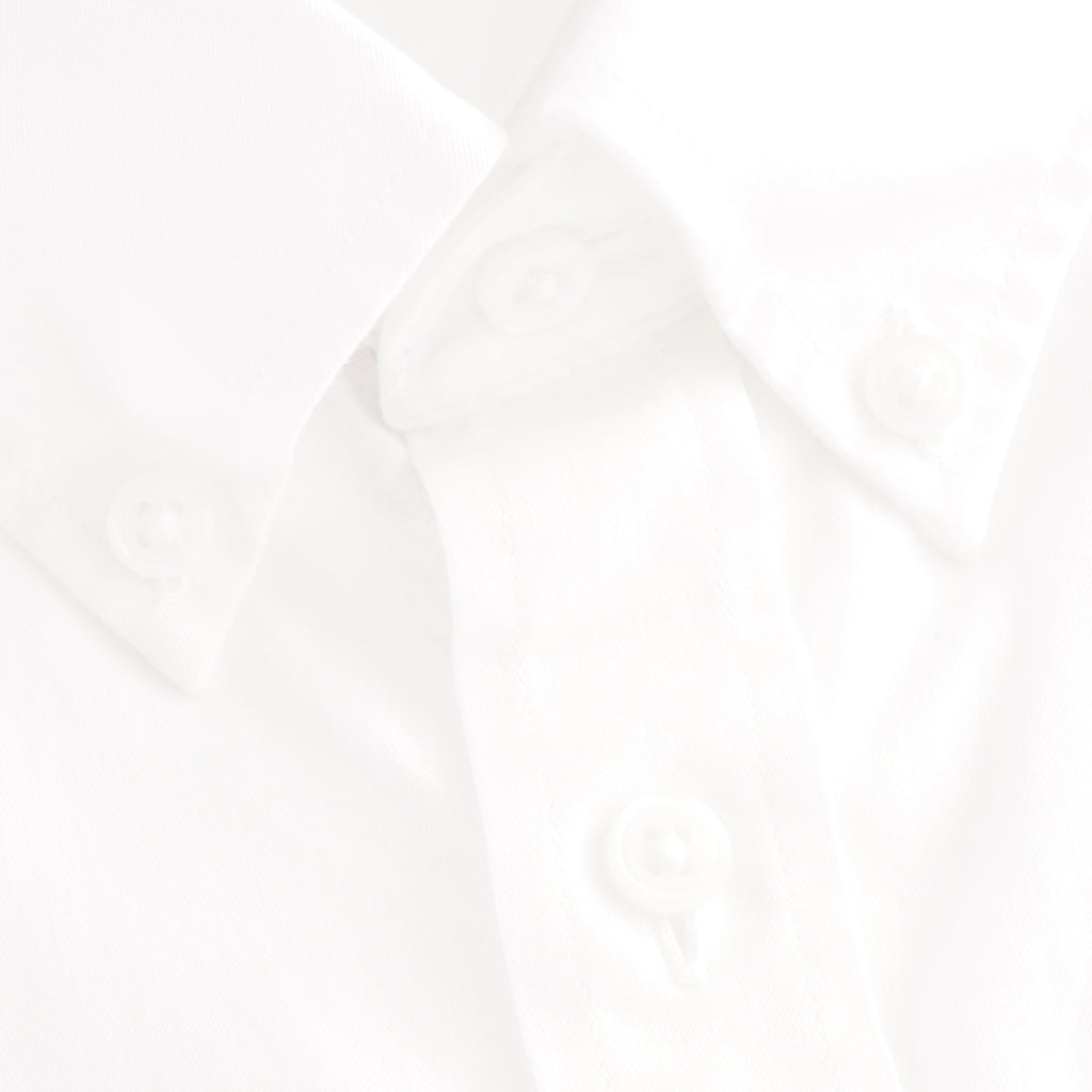 A close up of the white Tommy Hilfiger shirt buttons.