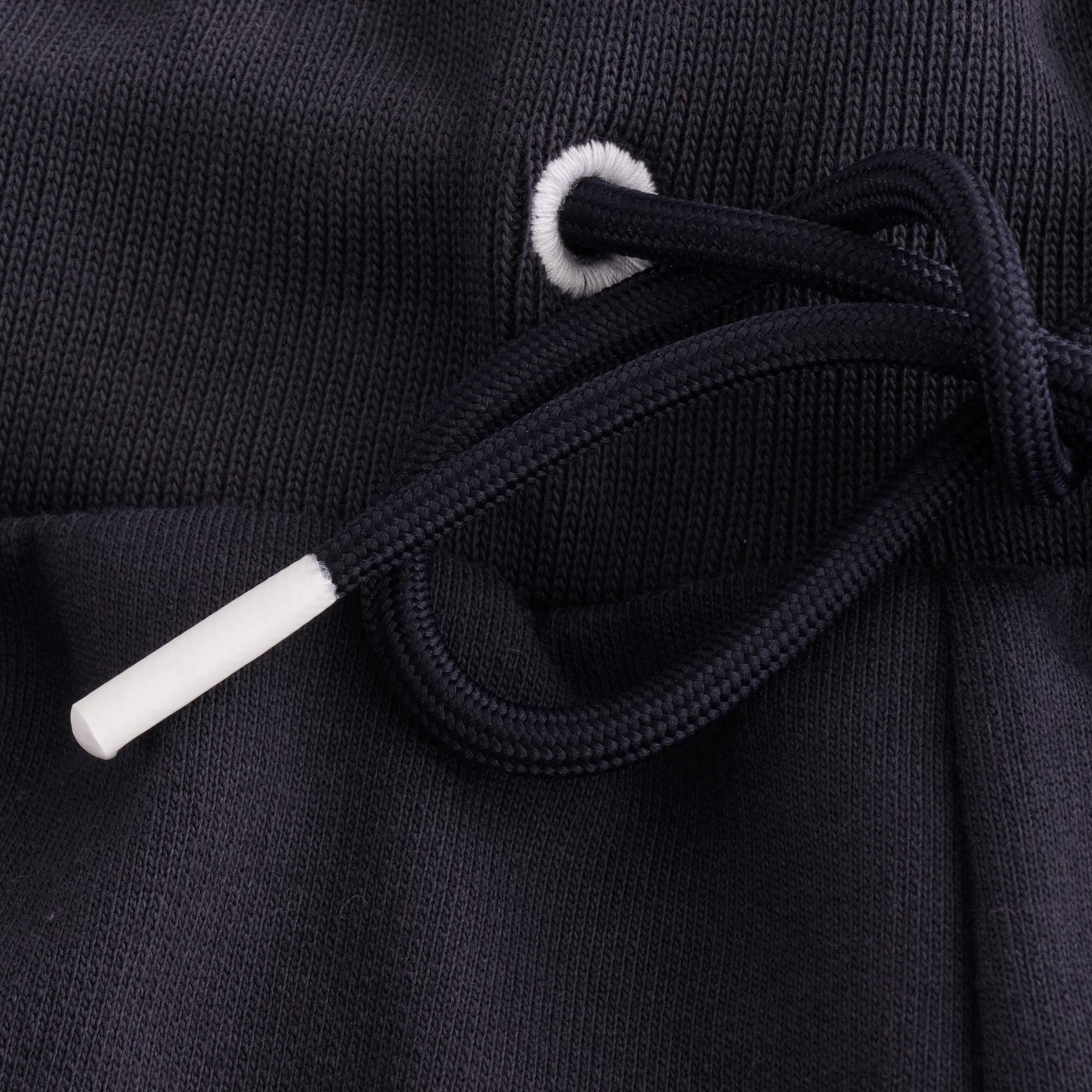 Close-up of the white-tipped drawstring and elastic waistband on the shorts.