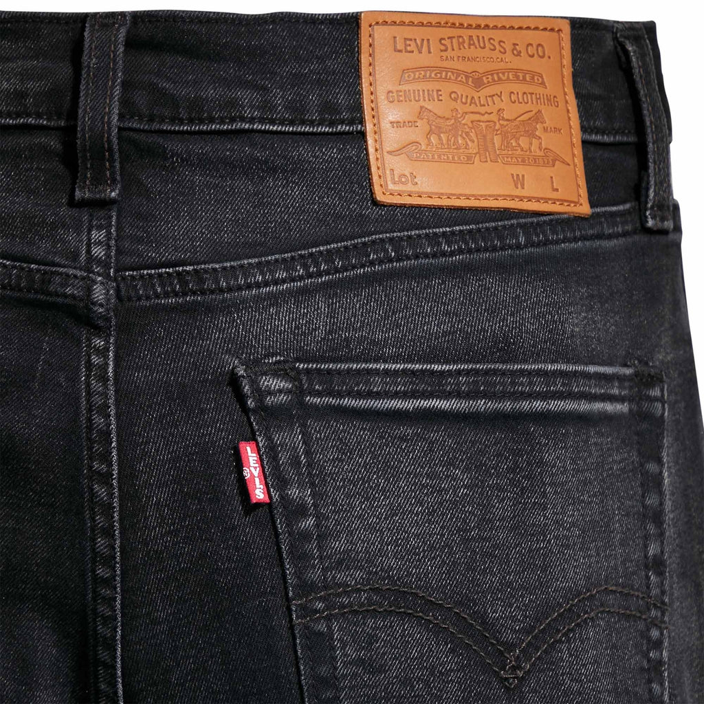 Close-up of the back pocket and leather patch on Levi's 519 men's black jeans.