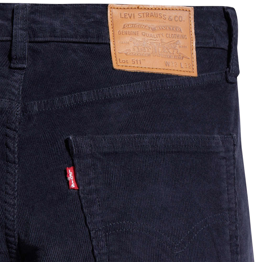 A close-up of the rear pocket and Levi's brand patch on navy corduroy trousers.