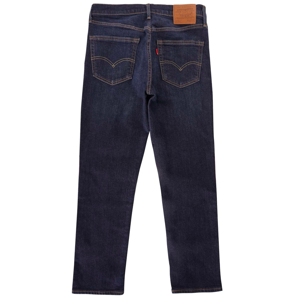 The back view of dark wash Levi's 511 slim fit jeans, laid flat on a white background.