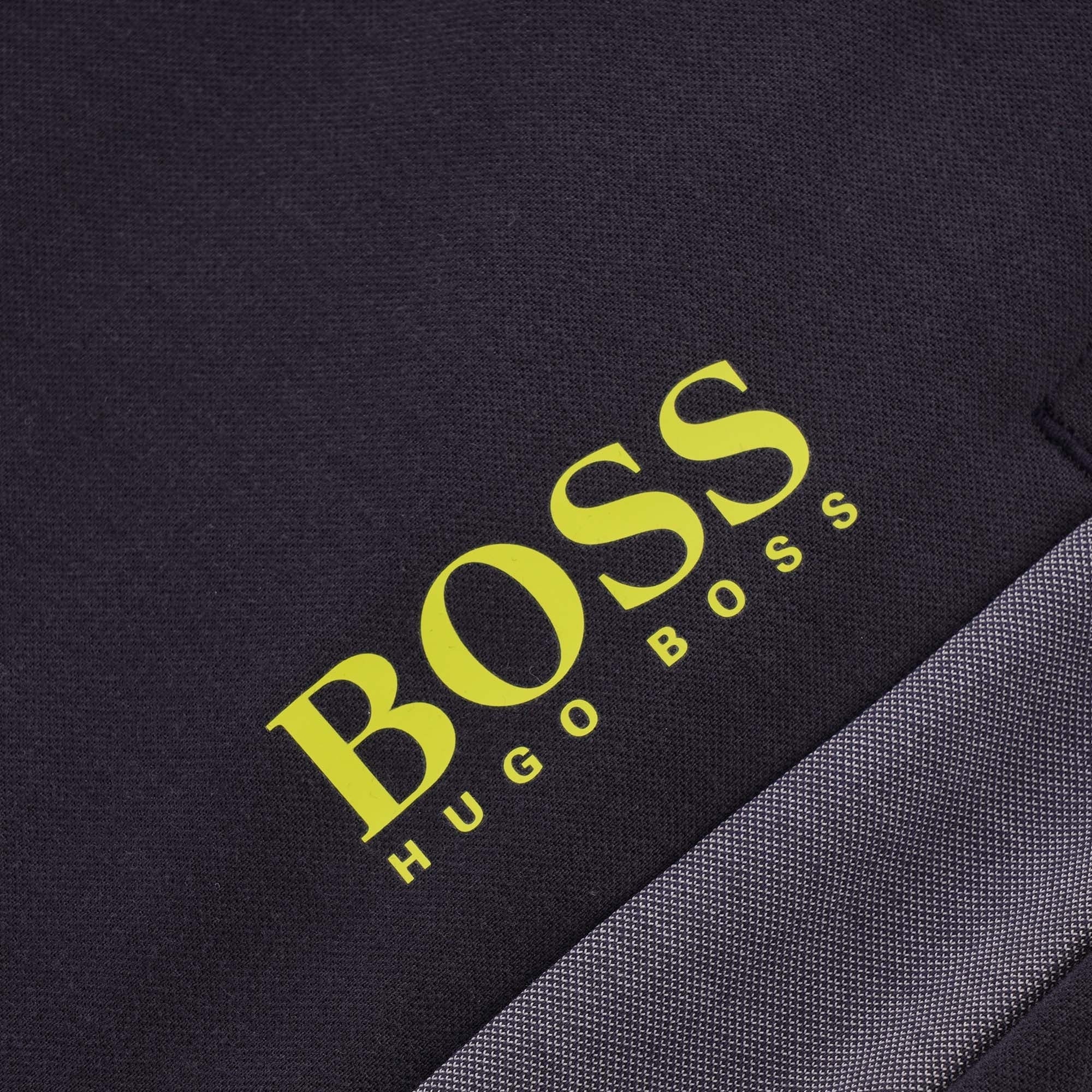 A close-up of the BOSS Hugo Boss logo on the tracksuit bottoms.