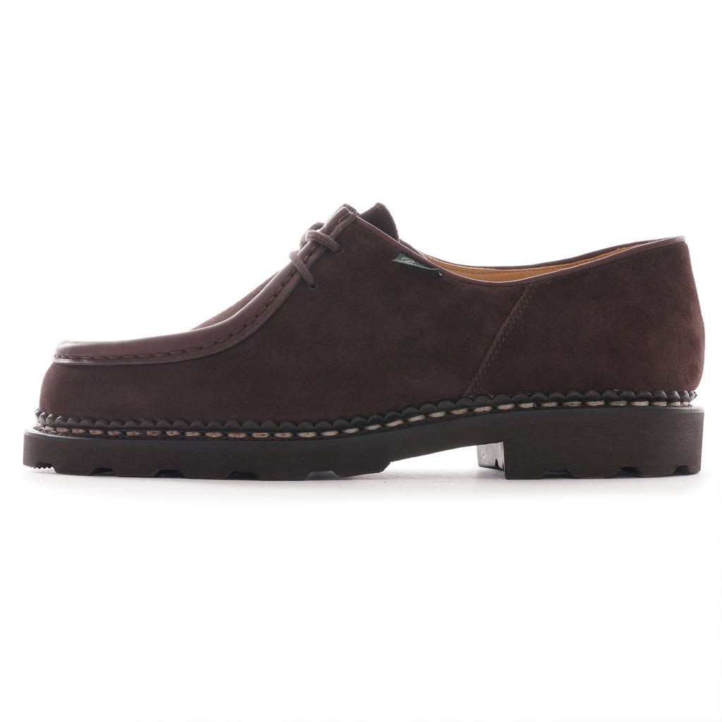 Brown suede men's shoe from the side showing stitching details.
