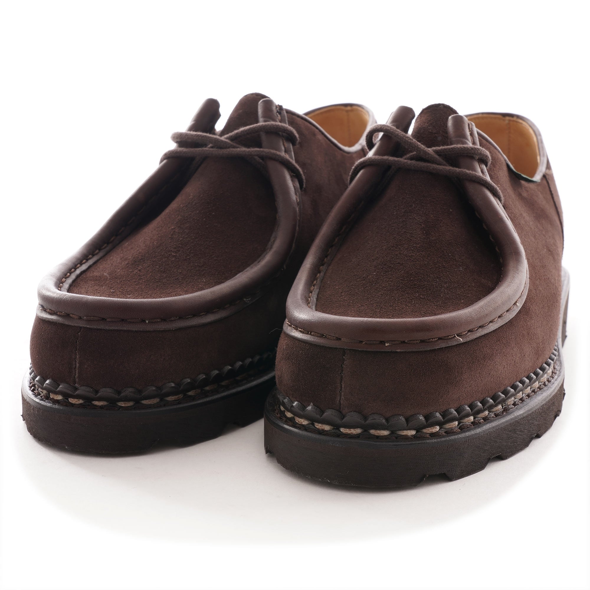 Pair of brown suede men's shoes from the front showing lace and stitching.
