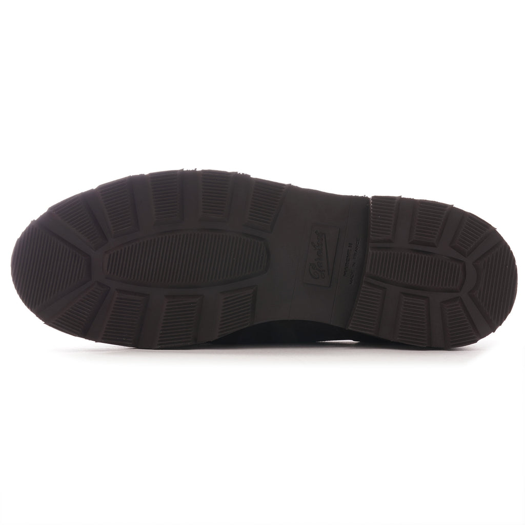 Underside of a brown shoe showing the tread and sole pattern.
