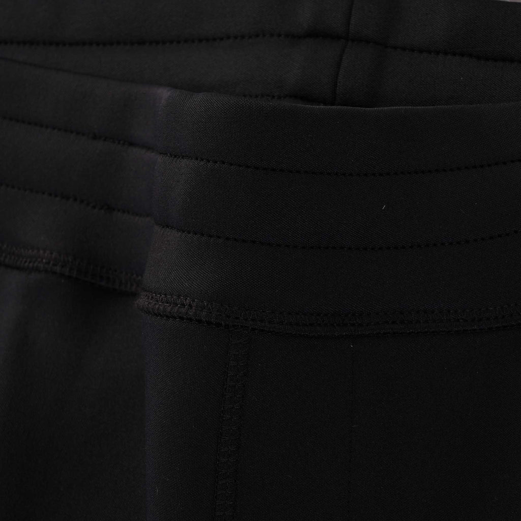 Close-up of the jogging bottoms' waistband, highlighting the stitched detailing and texture.