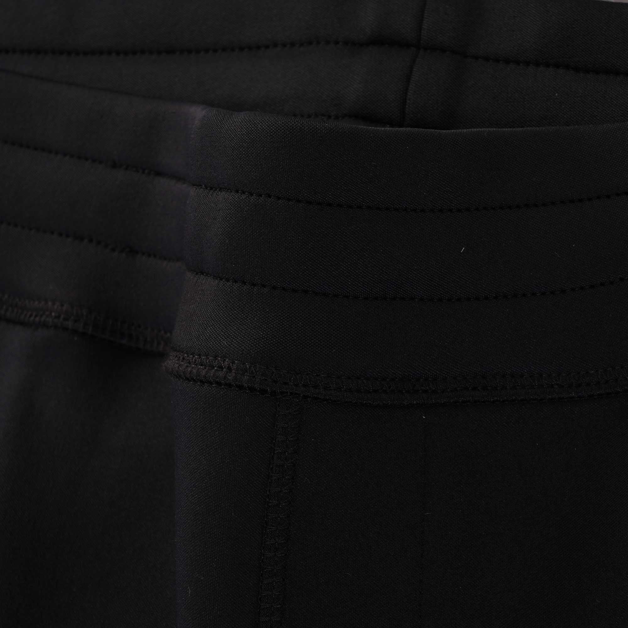 Close-up of the jogging bottoms' waistband, highlighting the stitched detailing and texture.