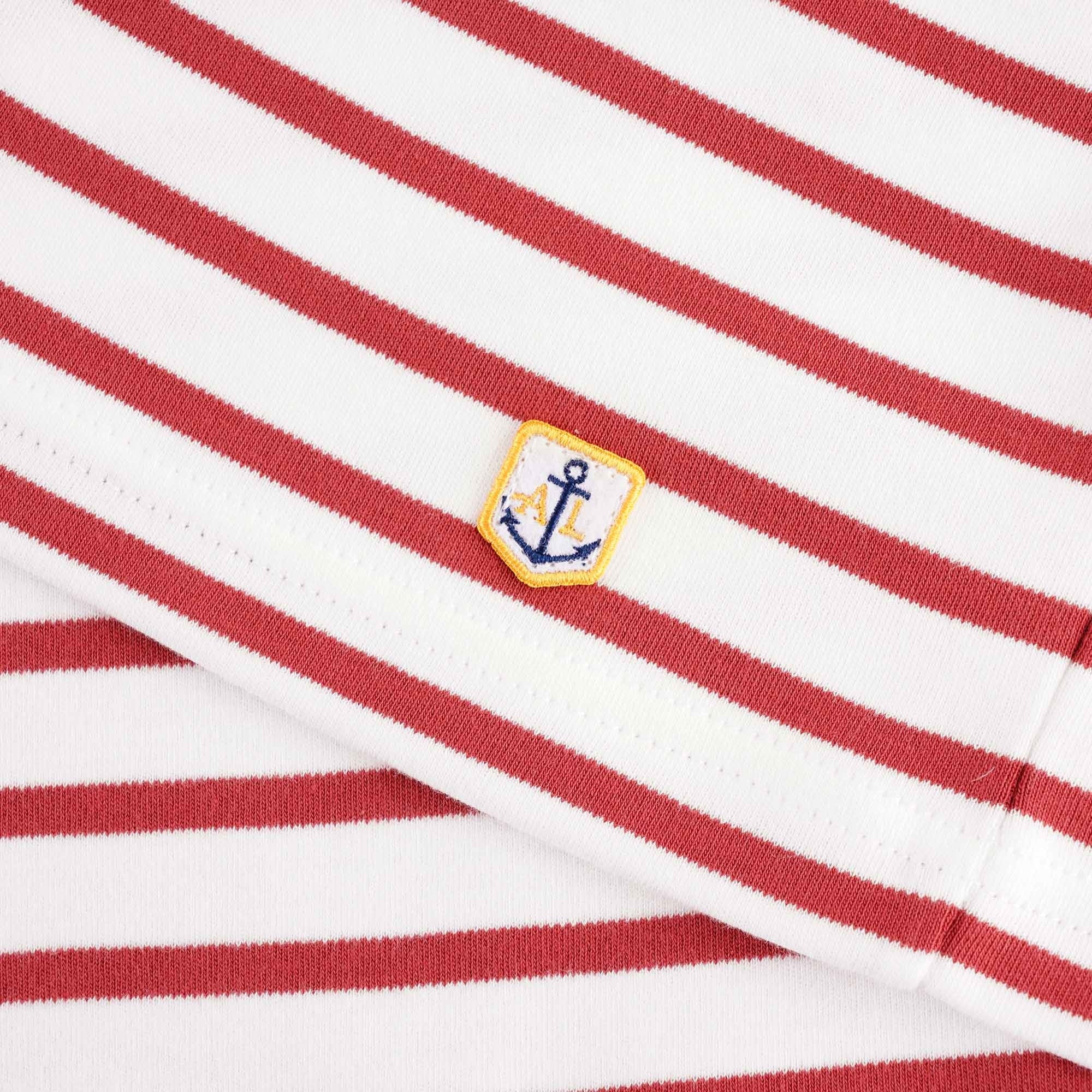 A close-up of the small anchor logo on the sleeve of the mariniere shirt. 