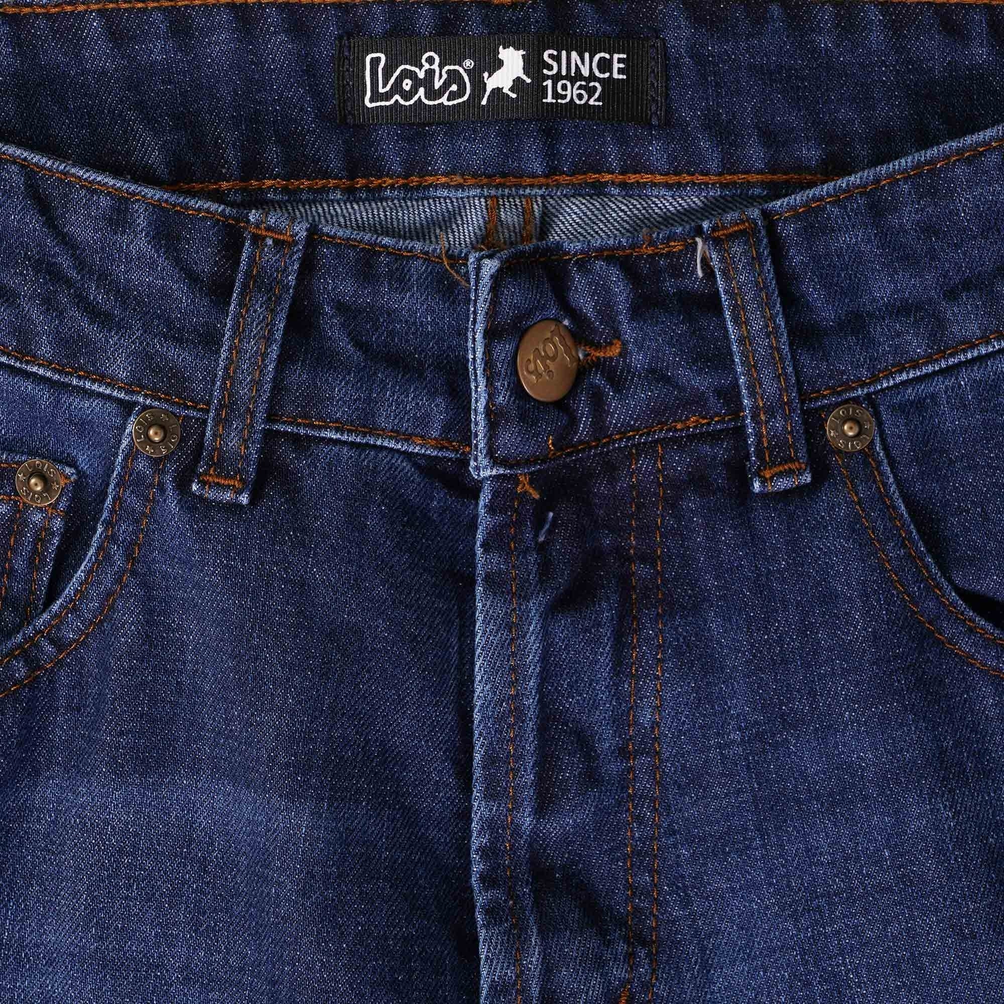 Close-up of the front fly and waist of dark blue Lois jeans, showing the button closure.