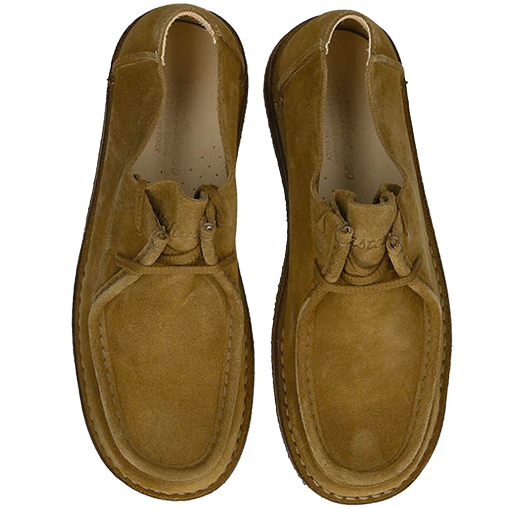 Top-down view of a pair of tan suede shoes showing the moccasin stitching.