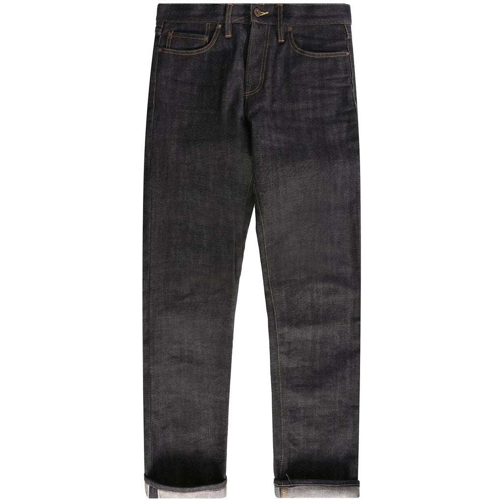 Full view of a pair of dark wash selvedge denim jeans with cuffed hems.