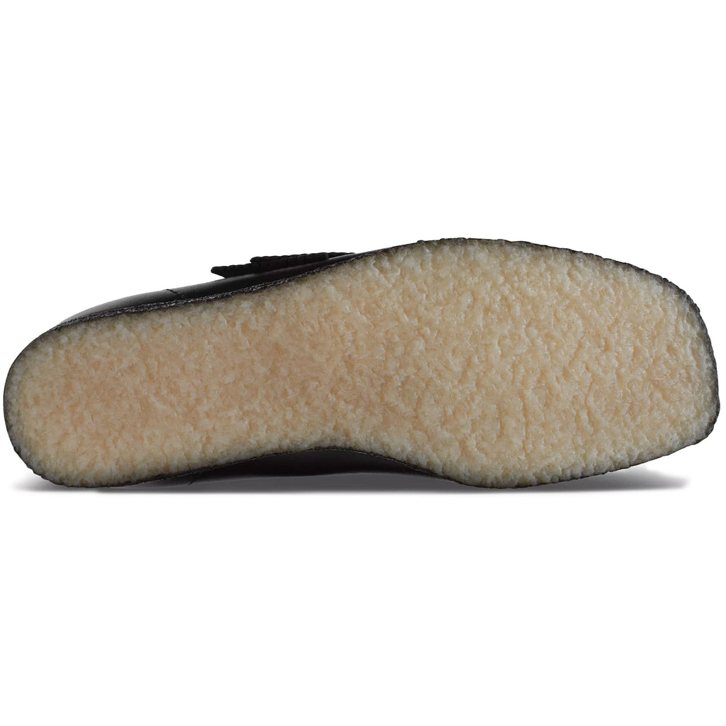 Underside of a black leather Clarks Originals Wallabee shoe, showing the crepe sole.