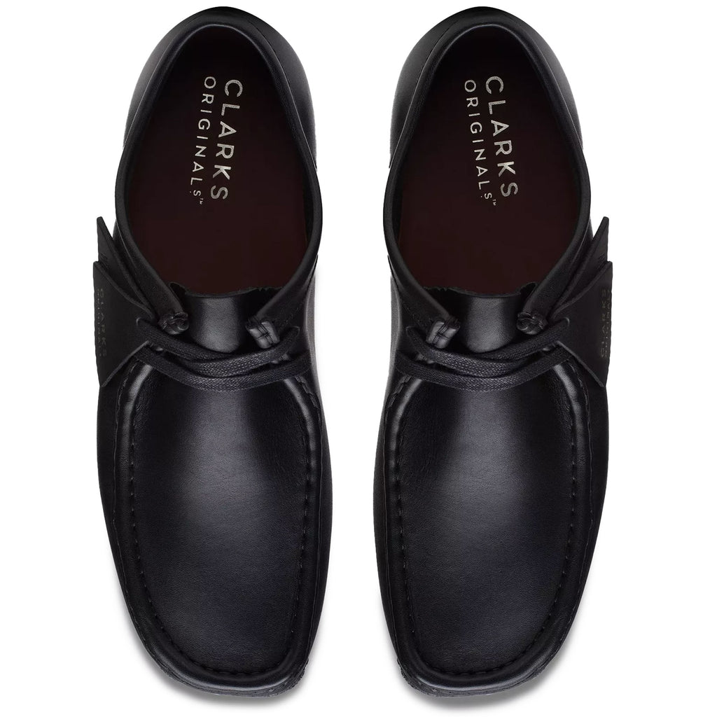 Top-down view of a pair of black leather Clarks Originals Wallabee shoes.