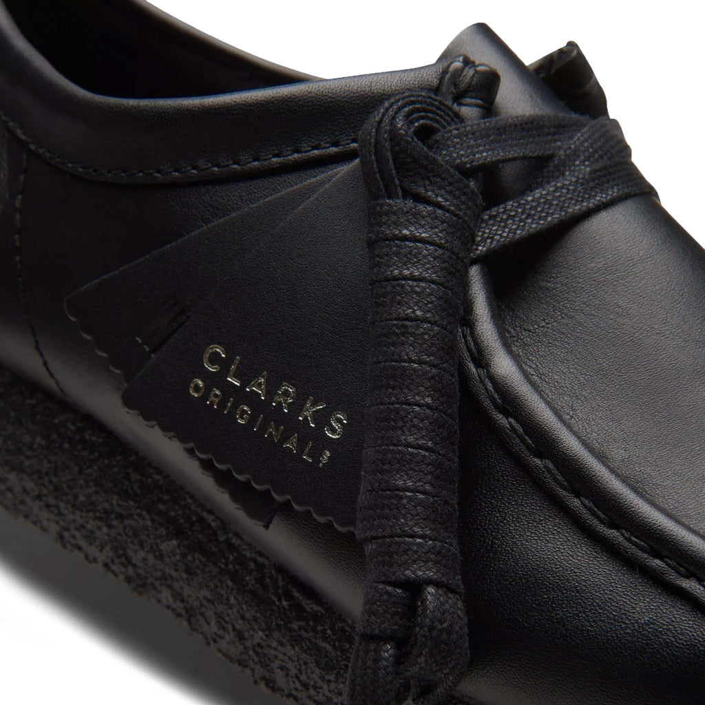 Close-up of the black leather Clarks Originals Wallabee shoe with branding tag.