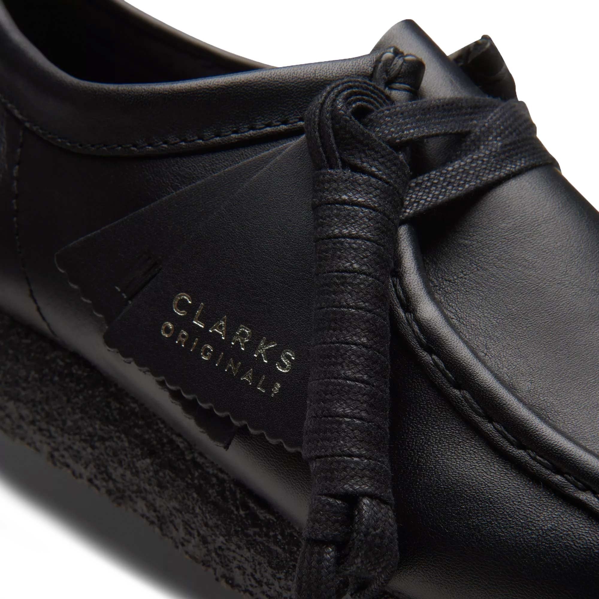 Close-up of the black leather Clarks Originals Wallabee shoe with branding tag.