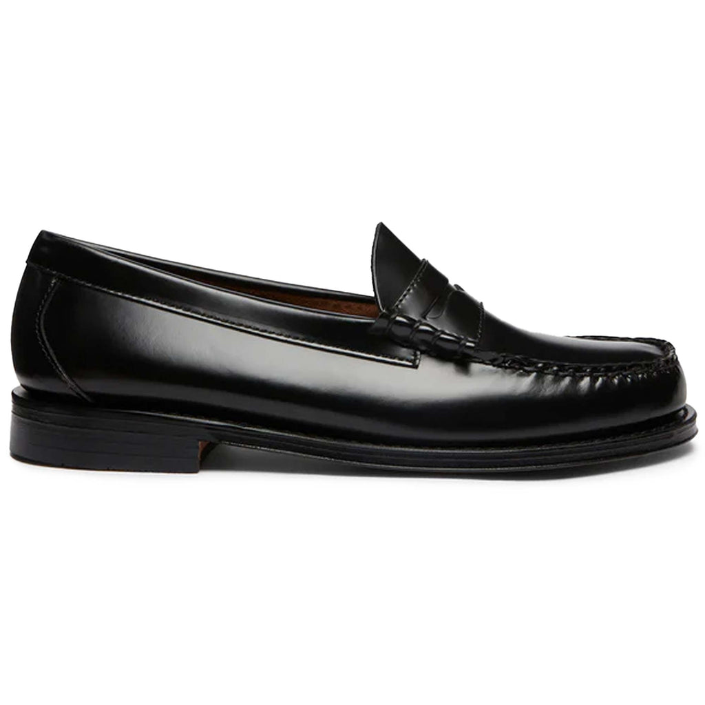 A single black leather Penny Loafer shoe, side view.