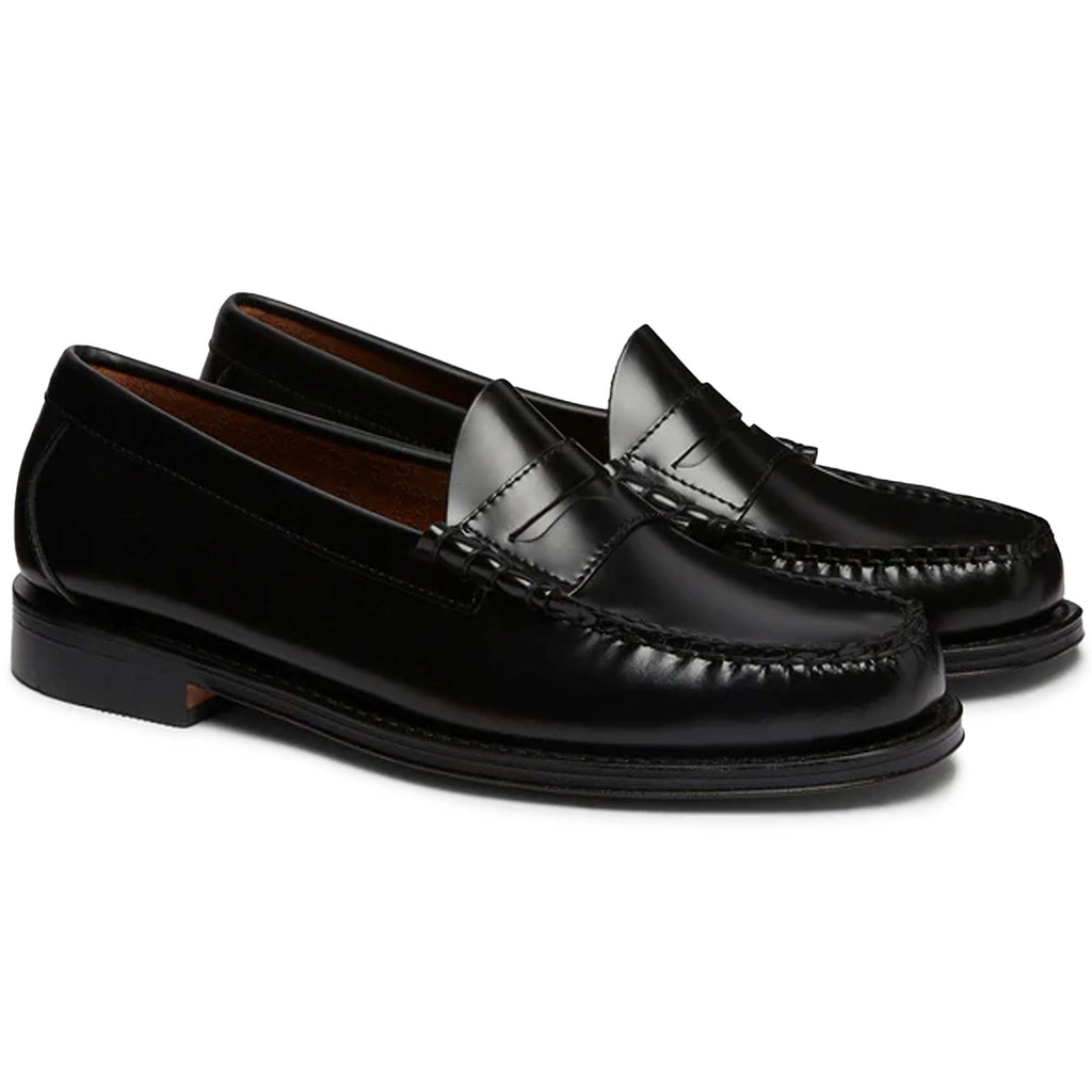 A pair of black leather Penny Loafer shoes, side view.